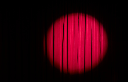 spotlight on red theatre curtain